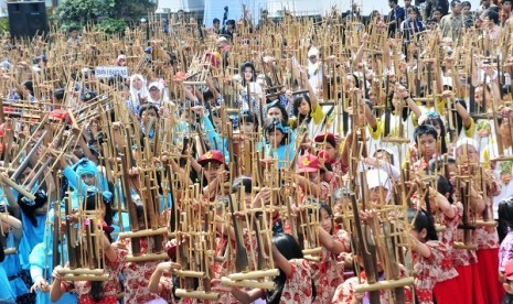 More than 2000 people play angklung, traditional musical instrument from West Java, on November 18, 2012 or known as Anglung Day, in Bandung, West Java. (illustration)