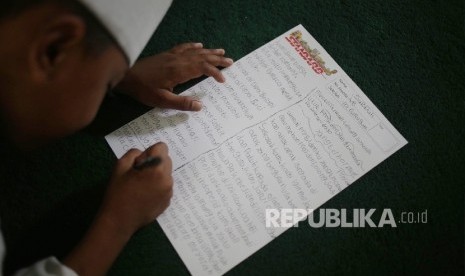 Murid-murid Madrasah Nurul Bahri menulis surat untuk Presiden RI Joko Widodo RI di perkampungan nelayan, Muara Angke, Jakarta Utara, Senin (27/2)