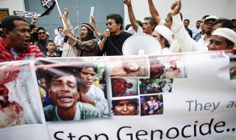 Muslims hold pictures and banners as they protest in front of Myanmar's embassy in Bangkok in June. A group of Rohingyas living in Thailand and other Muslims gathered outside the embassy demanding security for Myanmar's Rohingya people and called for inter