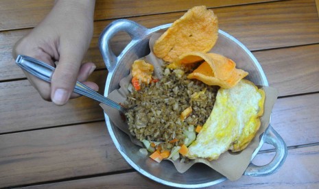 Nasi goreng. Memasak nasi goreng menjadi sulit ketika nasinya menempel di penggorengan.