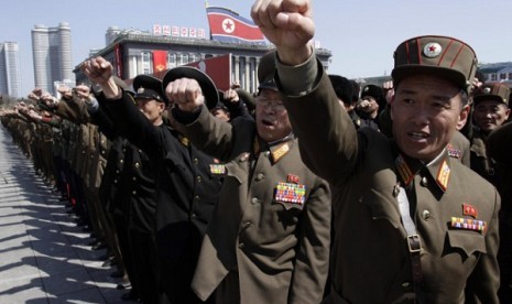 North Korean army officers punch the air as they chant slogans during a rally at Kim Il Sung Square in downtown Pyongyang, North Korea, Friday, March 29, 2013. 