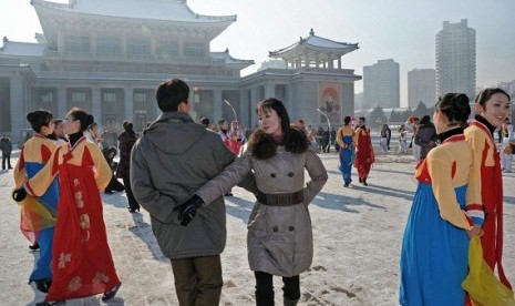 North Koreans dance to celebrate their country's rocket launch in Pyongyang, in this photo taken by Kyodo December 12, 2012.   