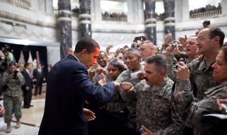 Obama memberi salam tinju kepada tentara AS saat ia menyambut pasukan di Camp Victory, Irak, 7 April 2009.