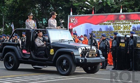 OPS Lilin 2014. Sejumlah anggota kepolisian bersiap untuk mengikuti apel gelar pasukan Operasi Pasukan Terpusat (OPS) Lilin di Lapangan Lalu Lintas, Polda Metro Jaya, Jakarta Selatan, Selasa (23/12).