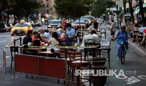 Orang-orang makan di luar di Columbus Avenue di New York, New York, AS, 22 Juni 2020. Kota New York secara resmi memulai Fase Dua dengan sebagian besar kegiatan dibuka kembali setelah ditutup selama 100 hari karena pandemi coronavirus. 