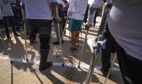 Orang-orang Palestina yang diamputasi mengikuti lomba memperingati Hari Penyandang Disabilitas Internasional di kamp pengungsi Nuseirat, di Jalur Gaza tengah, Kamis, 8 Desember 2022. Lomba Marathon Digelar di Jalur Gaza Peringati Hari Penyandang Disabilitas Internasional