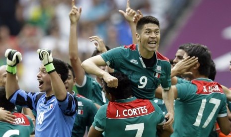 Oribe Peralta (9) dan Javier Cortes (7) merayakan kemenangan mereka setelah memastikan medali emas dalam pertandingan final olimpiade London 2012 mengalahkan Brasil. 