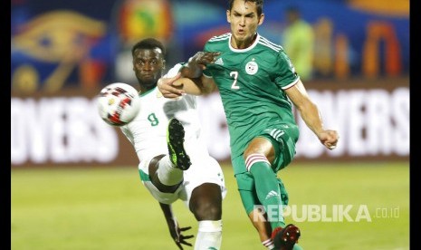 Striker Senegal Mbaye Niang berebut bola dengan bek Aljazair Aissa Mandi (kanan) pada pertandingan Grup C Piala African antara Aljazair dan Senegal di Kairo, Jumat (28/6). 