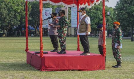 Panglima TNI Marsekal TNI Hadi Tjahjanto (kedua kiri) didampingi Kapolri Jenderal Polisi Listyo Sigit Prabowo (kiri) dan Kepala BNPB Letjen TNI Ganip Warsito (tengah) memimpin apel bersama di Pekalongan, Jawa Tengah, Ahad (6/6/2021). Dalam kesempatan itu, Panglima TNI menyampaikan imbauan agar warga Pekalongan melaksanakan protokol kesehatan ketat hingga ke tingkat skala mikro berbasis RT dan RW.