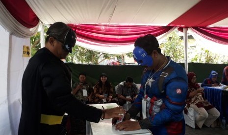 Panitia Pemungutan Suara di TPS 005 Kelurahan Babat Jerawat, Kecamatan Pakal, Surabaya, berpakaian ala super hero di Avenger untuk menarik minat masyarakat menyalurkan hak pilihnya pada Pemilu 2019, Rabu (17/4).