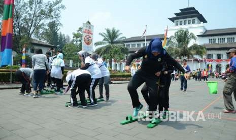 Para pegawai Sekretariat Daerah Provinsi (Setda) Jawa Barat ikut serta dalam lomba permainan tradisional Festival Aktivitas Kaulinan Urang Lembur (Akur) di halaman Gedung Sate, Kota Bandung, Senin (27/8).