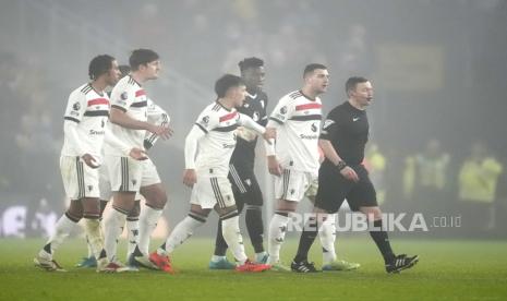 Para pemain Manchester United memprotes keputusan wasit Tony Harrington yang mengeluarkan Bruno Fernandes dalam laga Liga Primer Inggris kontra Wolverhampton Wanderers (Wolves) di Stadion Molineux, Jumat (27/12/2024) dini hari WIB. MU takluk 0-2 dalam pertandingan ini.