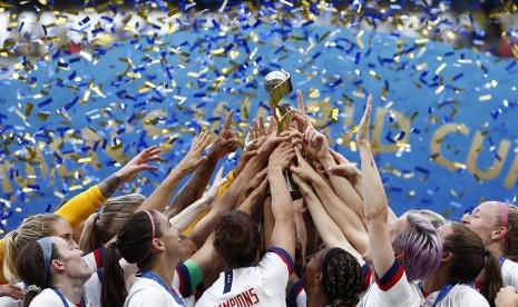 Para pemain tim sepak bola wanita Amerika Serikat mengangkat trofi juara Piala Dunia Wanita 2019.