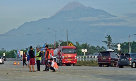 Para pemudik yang sedang melakukan arus balik, tampak beristirahat dan menikmati suasana pagi di rest area 487 B, Boyolali di ruas tol Semarang- Solo, Jumat (7/6). Rest area fungsional ini memiliki daya tarik pemandangan gunung Merapi yang tampak menjulang.