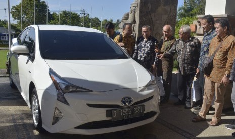 Para perwakilan perguruan tinggi yang terlibat dalam studi komprehensif mobil listrik Kemenperin mengamati mobil Toyota Prius Hybrid Electric Vehicle (HEV) usai kegiatan pemaparan Laporan Akhir Fase-2 Riset Komprehensif Mobil Listrik dengan Melibatkan Perguruan Tinggi di Universitas Udayana, Jimbaran, Bali, Selasa (23/4/2019).