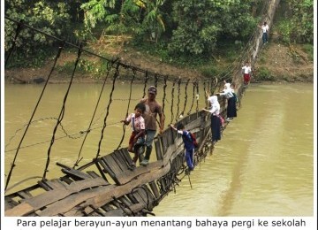 Para Siswa menyeberangi sungai saat akan bersekolah