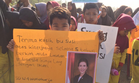 Para siswa meyambut kedatangan Susi Pudjiastuti di landasan pacu Pamugaran, Kecamatan Pangandaran, Kabupaten Pangandaran, Sabtu (26/10). 