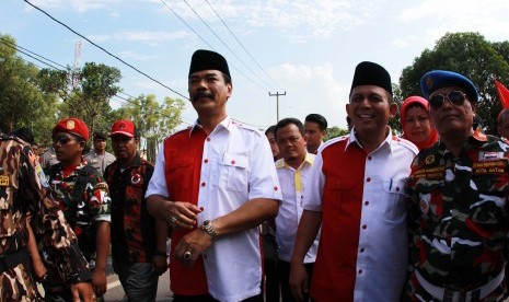 Pasangan Calon Gubernur Kepulauan Riau (Kepri) Soeryo Roespationo (kiri) dan wakilnya Ansar Ahmad dikawal pendukungnya saat mendaftar Pilkada di KPU Provinsi Kepri, Tanjungpinang, Kepri, Senin (27/7). 