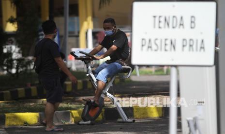 Pasien COVID-19 berolahraga saat menjalani karantina di Rumah Sakit Lapangan Kogabwilhan II Indrapura (RSLKI) di Surabaya, Jawa Timur, Jumat (11/6/2021). Usai penyekatan di Jembatan Suramadu, jumlah pasien yang dirawat di rumah sakit berkapasitas tempat tidur sebanyak 400 ranjang tersebut hingga Jumat (11/6/2021) pagi bertambah 110 orang sehingga total jumlah pasien menjadi 269 orang.