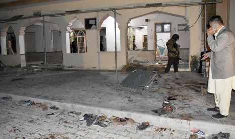 Pasukan keamanan memeriksa lokasi ledakan bom di sebuah masjid di Quetta, Pakista, Jumat (10/1). 