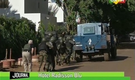 Pasukan tentara Mali mendekati lokasi Hotel Radisson Blu  di Bamako, Mali, Jumat (20/11).  (AP/Mali TV)