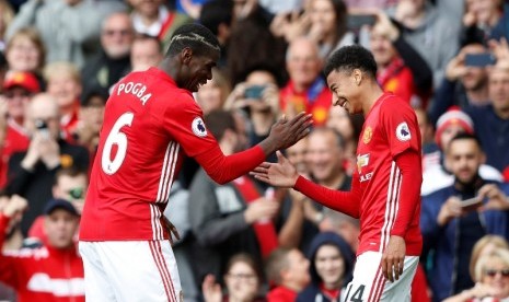 Paul Pogba (kiri) merayakan gol keempat Manchester United yang dicetaknya ke gawang Leicester City bersama Jesse Lingard.