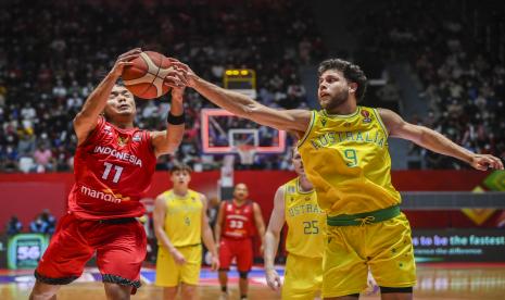 Pebasket Indonesia Yudha Saputera (kiri) berebut bola dengan pebasket Australia William Mcdowll-White (kanan) dalam babak penyisihan Grup A FIBA Asia Cup 2022 di Istora Gelora Bung Karno, Senayan, Jakarta, Sabtu (16/7/2022). Australia menang atas Indonesia dengan skor 78-53. 