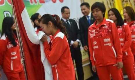 Pebulutangkis putri anggota tim Uber Indonesia Maria Febe Kusumastuti mencium bendera merah putih saat pelepasan Tim Thomas dan Uber 2016 di Pelatnas PBSI, Cipayung, Jakarta, Senin (9/5). 