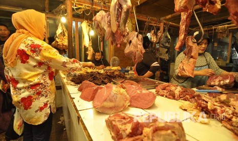 Pedagang daging sapi melayani pembeli di Pasar Kosambi, Kota Bandung. Senin (4/7). Saat ini harga daging sapi naik dari Rp 120.000 menjadi Rp 130.000 Per kilogramnya. (Mamu Muhyidin)