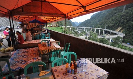 Pedagang kaki lima (PKL) membuka lapak di tepi flyover Kelok Sembilan, di Kabupaten Limapuluhkota, Sumatera Barat, Sabtu (5/5). 