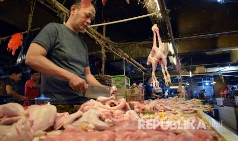 Pedangang memotong daging ayam di Pasar Kosambi, Kota Bandung.