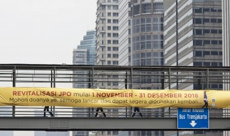 Pejalan kaki melintas di Jembatan Penyeberangan Orang (JPO) Gelora Bung Karno, Jakarta, Kamis (1/11/2018).