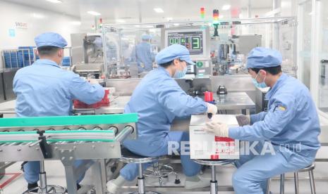 Pekerja bagian pengemasan Sinovac Biotech Ltd beraktivitas di pabrik barunya di kawasan Daxing, Beijing, China, Selasa (18/1/2022). Beroperasinya pabrik baru tersebut, Sinovac mampu menghasilkan tiga hingga empat miliar dosis vaksin COVID-19 per tahun.