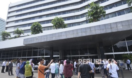 Pekerja berhamburan keluar Gedung Nusantara I saat merasakan gempa di Kompleks Parlemen, Senayan, Jakarta, Selasa (23/1). 