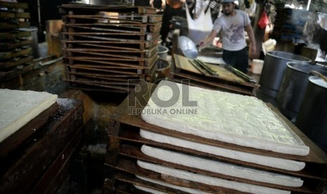 Pekerja melakukan proses pembuatan tahu di salah satu pabrik di Mampang, Jakarta, Rabu (11/3).