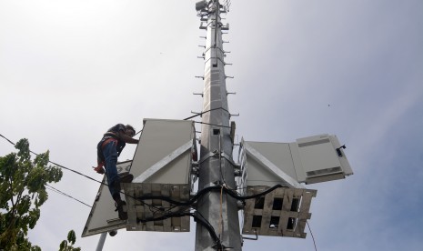 Pekerja memasang perangkat untuk mendukung teknologi jaringan seluler Fourth Generation Technology (4G) di salah satu Based Tranceiver Group (BTG) di Palu, Sulawesi Tengah, Selasa (17/5). 