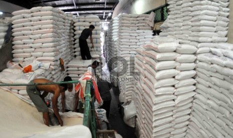 Pekerja memasukan beras kedalam karung di Pasar Induk Cipinang, Jakarta, Kamis (15/10). 