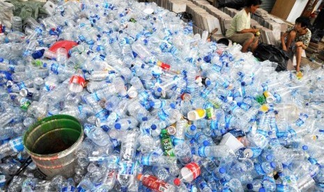 Pekerja membersihkan botol plastik bekas di penampungan botol bekas, Jakarta, Selasa (6/5).