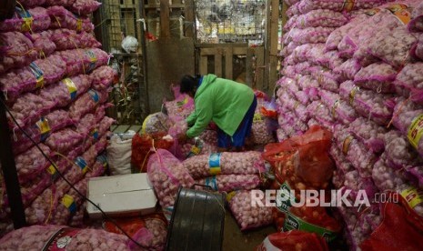 Pekerja memilah  bawang putih di Pasar Induk Kramat Jati, Jakarta, Jumat (6/7). 