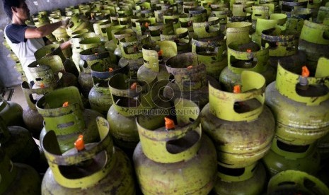 Pekerja memindahkan sejumlah tabung LPG 3 kilogram untuk didistribusikan ke pengecer di salah satu agen di Jakarta, Senin (23/2).