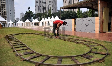 Pekerja mempersiapkan sejumlah wahana arena bermain anak untuk meramaikan Pesta Rakyat Jakarta di Parkir Timur, Senayan, Jakarta Pusat, Rabu (27/5).