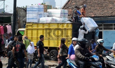 Pekerja mengatur paket di atas truk yang yang mengantarkan barang kiriman dari Pasar Tanah Abang, Jakarta Pusat. Truk tersebut kerap jadi sasaran pungli preman yang meminta sejumlah uang. 