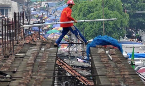 Pekerja mengerjakan proyek jembatan penghubung di Pasar Tanah Abang, Jakarta Pusat, Kamis (27/2).  (Republika/Rakhmawaty La'lang)