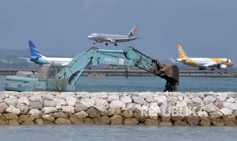 Pekerja menggunakan alat berat melakukan pengerjaan persiapan perluasan apron sisi barat Bandara Internasional Ngurah Rai, Bali, Kamis (3/5).