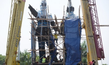 Pekerja menggunakan alat berat melakukan persiapan pemindahan Patung Proklamator Soekarno-Hatta di Jalan Raya Bandara Soekarno-Hatta, Tangerang, Banten, Kamis (7/1). 