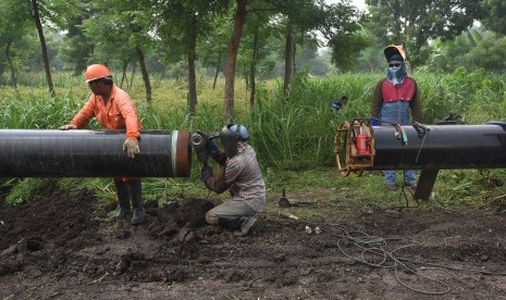 Pekerja menyambung pipa penyaluran gas pada proyek pembangunan pipa transmisi gas ruas Porong - Grati milik Pertamina Gas (Pertagas) di Pasuruan, Jawa Timur.