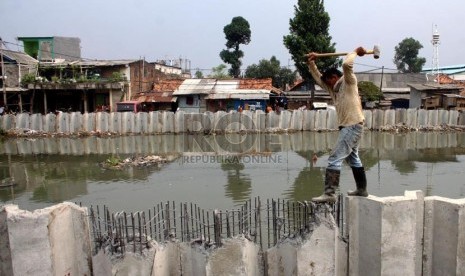  Pekerja menyelesaikan pemasangan turap Sungai Mookervart di Jalan Daan Mogot, Jakarta Barat, Kamis (7/11).  (Republika/Yasin Habibi)