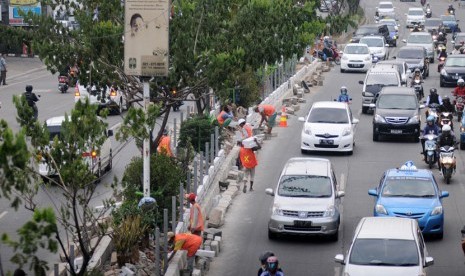 Pekerja menyelesaikan pembuatan pelebaran taman separator di Jalan Margonda Raya, Depok, Jawa Barat, belum lama ini.