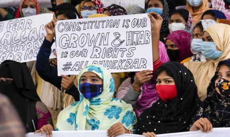 Pelajar India, beberapa memegang plakat, berpartisipasi dalam prosesi untuk memprotes larangan gadis Muslim berhijab menghadiri kelas di beberapa sekolah di negara bagian Karnataka, India selatan, di Kolkata, India, Rabu, 9 Februari 2022. Gadis Muslim berhijab dilarang menghadiri kelas di beberapa sekolah di negara bagian Karnataka, India selatan, yang memicu protes selama berminggu-minggu oleh para siswa. 