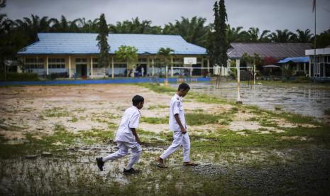 Pelajar melintas di depan sekolah (Ilustrasi). Kebijakan masuk sekolah pukul 05.00 Wita dinilai tidak berkorelasi dengan capaian kualitas pendidikan di NTT.